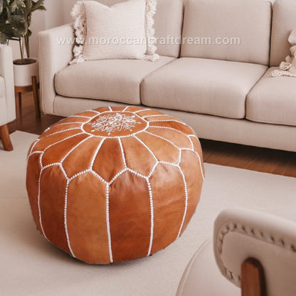 Caramel Handcrafted Moroccan leather pouf ottoman, versatile as a coffee table or foot stool, made from high-quality leather for a stylish and functional addition to any room decor.