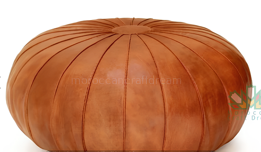 Round Moroccan leather poufs used as a coffee table, handcrafted with durable materials and traditional stitching in natural tones.