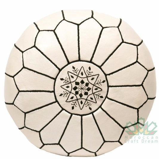 cream beige Handmade round Moroccan pouf ottoman in genuine leather, perfect for use as a versatile coffee table or footrest. This Moroccan leather ottoman enhances living room decor with its elegant design and multifunctional use. Crafted from high-quality leather, Moroccancraftdream's leather poufs offer a stylish and practical solution for modern living spaces. Ideal for use as a coffee table or seating, this round pouf adds a touch of sophistication to any room