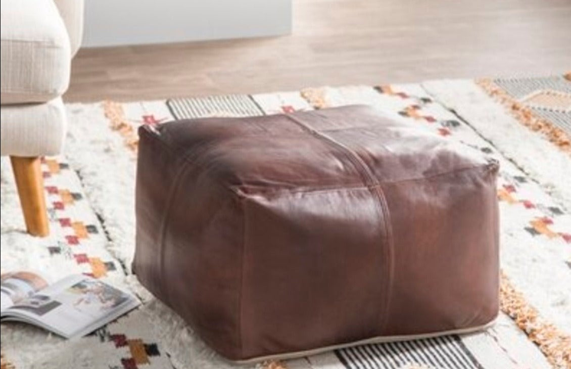 Handcrafted Moroccan leather pouf in chocolate brown color, perfect for living room decor and extra seating.