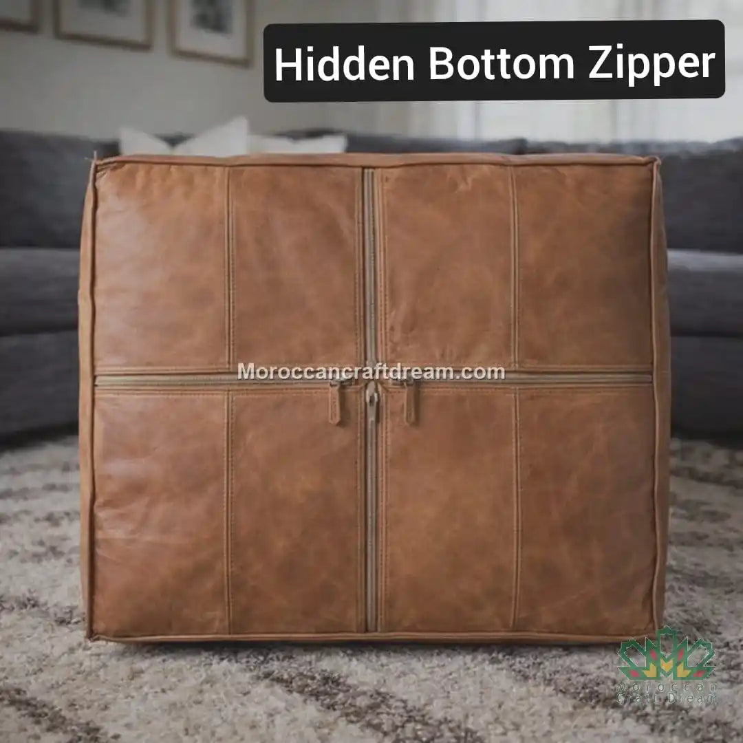 light caramel extra large leather ottoman coffee table with a hidden bottom zipper on a carpeted floor.