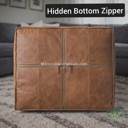 light caramel extra large leather ottoman coffee table with a hidden bottom zipper on a carpeted floor.