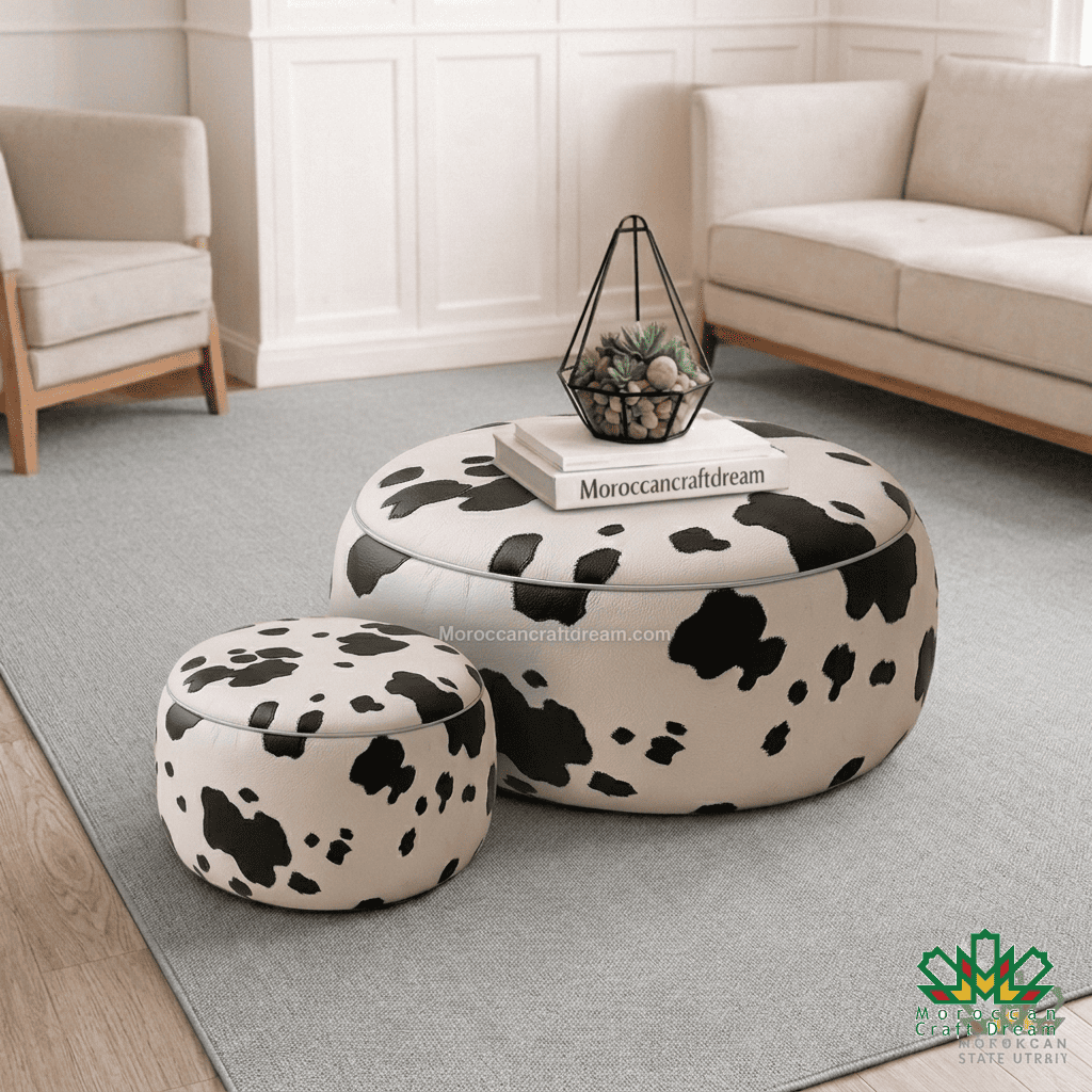 A pair of round ottoman stools with a black and off-white dog print pattern, styled in a bright living room setting on a gray rug.