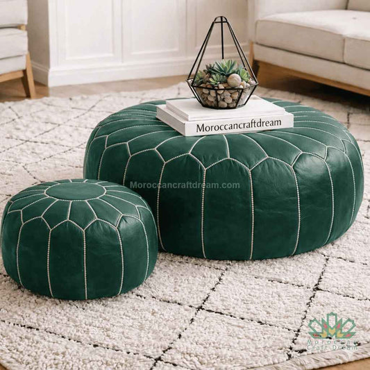 Green leather ottomans on a textured rug with a decorative stand and books.