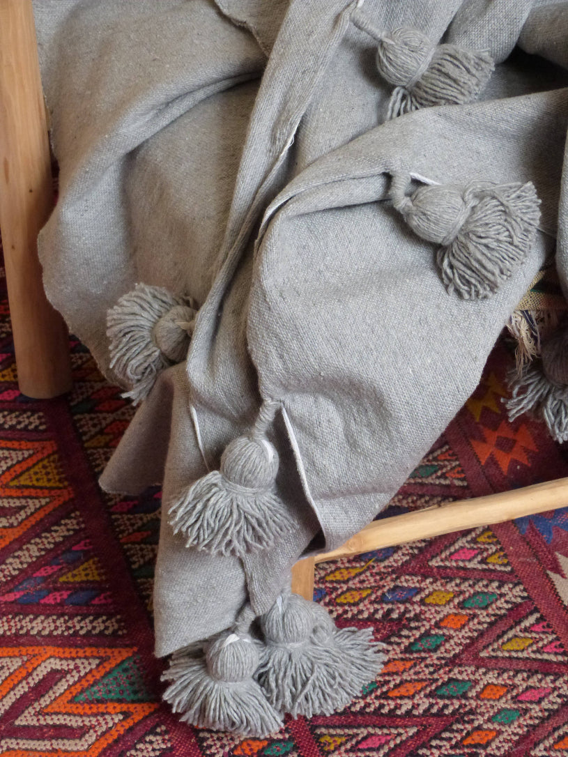 moroccan handmade blanket craft marrakech grey pompoms, boho decor