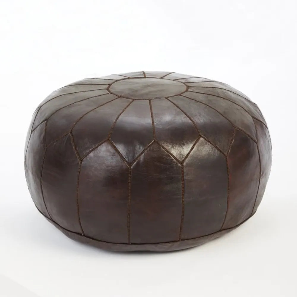 Handmade Moroccan leather pouf ottoman used as a coffee table, in authentic goatskin leather, perfect for versatile home decor.