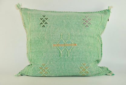 green Close-up of Moroccan hand-loomed cactus silk pillow with vibrant colors