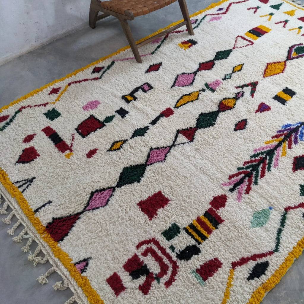 Natural wool Moroccan carpet with handcrafted Berber design for cozy home décor.