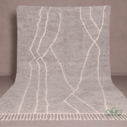 Gray textured blanket with white lines and fringes on a plain background