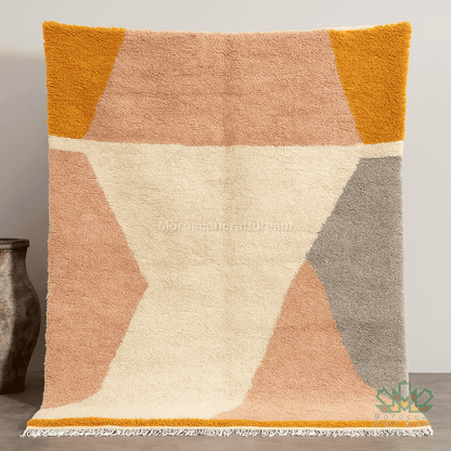 Textured area rug with geometric pattern in warm colors on a neutral background