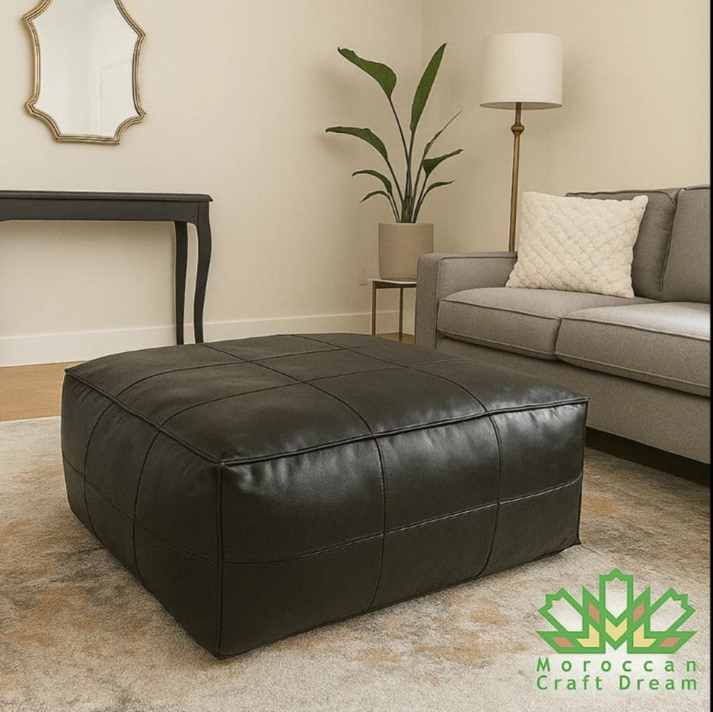 Black large square leather ottoman in a living room 