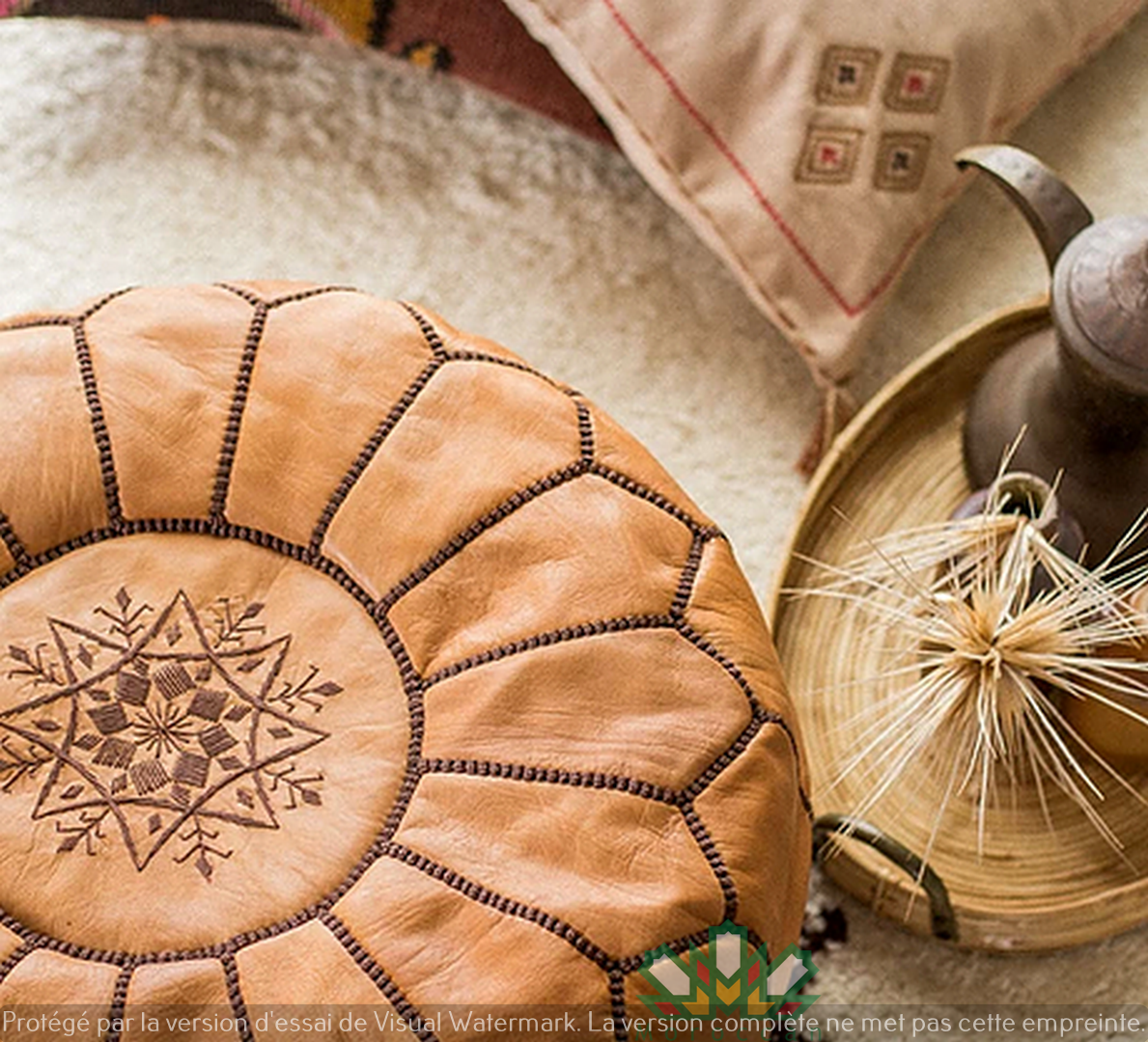 Light caramel handmade Moroccan leather pouf ottoman with black stitching in neutral tones, designed for living room decor and additional seating.