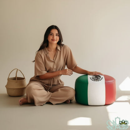 Woman sitting on a stool with Mexican flag design next to a woven basket on a plain background