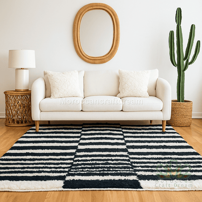 Living room with a white sofa, striped rug, and cactus plant.