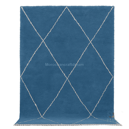 Blue rug with white diamond patterns on a light gray background, featuring the brand 'MoroccanCraftDream'.