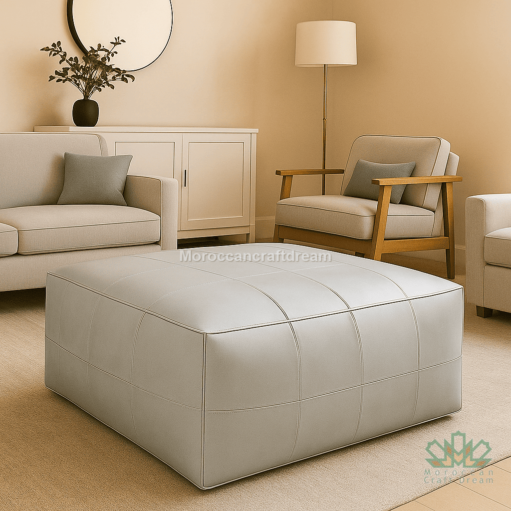 Beige living room with a sofa, armchair, and ottoman, featuring 'MoroccanCraftDream' branding with pearl gray leather ottoman coffee table.