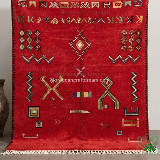 Authentic handcrafted Moroccan wool rug in brick red with colorful geometric symbols and white fringes, large area rug for organic modern and luxury interior design.