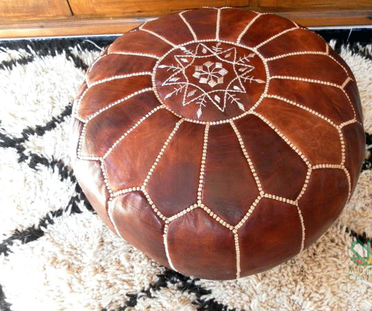 Elegant pre-stuffed round leather ottoman dark tan moroccan pouf used as footstool, pouf or coffee table
