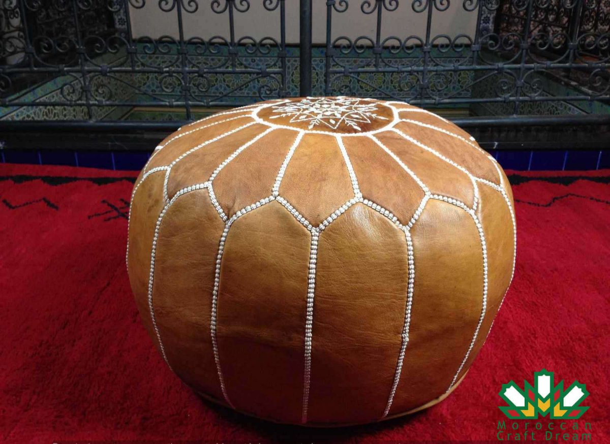 pre-stuffed light caramel Moroccan pouf leather ottoman, suitable as additional seating, footrest, or stylish coffee table.