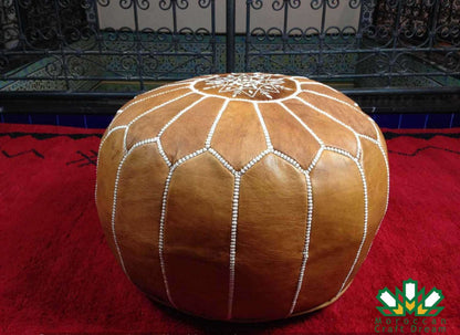 pre-stuffed light caramel Moroccan pouf leather ottoman, suitable as additional seating, footrest, or stylish coffee table.