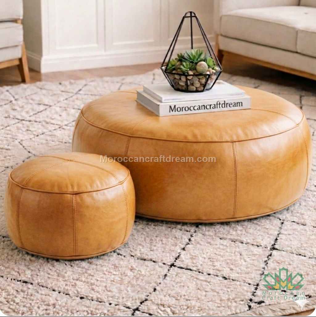 Tabac Round leather ottoman and stool set on a textured rug with 'MoroccanCraftDream' branding.