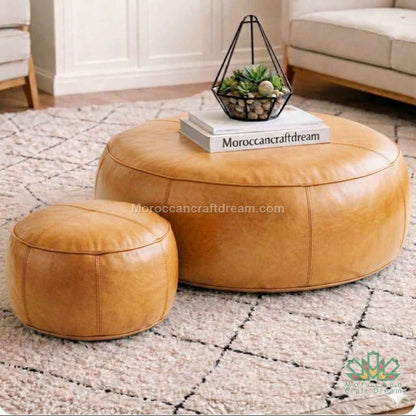 Tabac Round leather ottoman and stool set on a textured rug with 'MoroccanCraftDream' branding.
