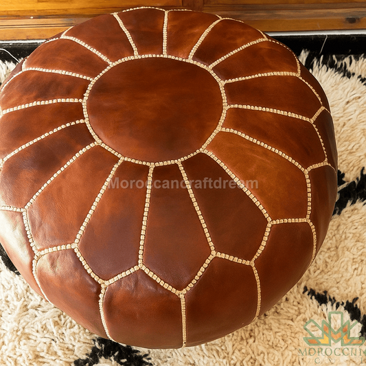 Brown leather ottoman with geometric pattern on a textured surface
