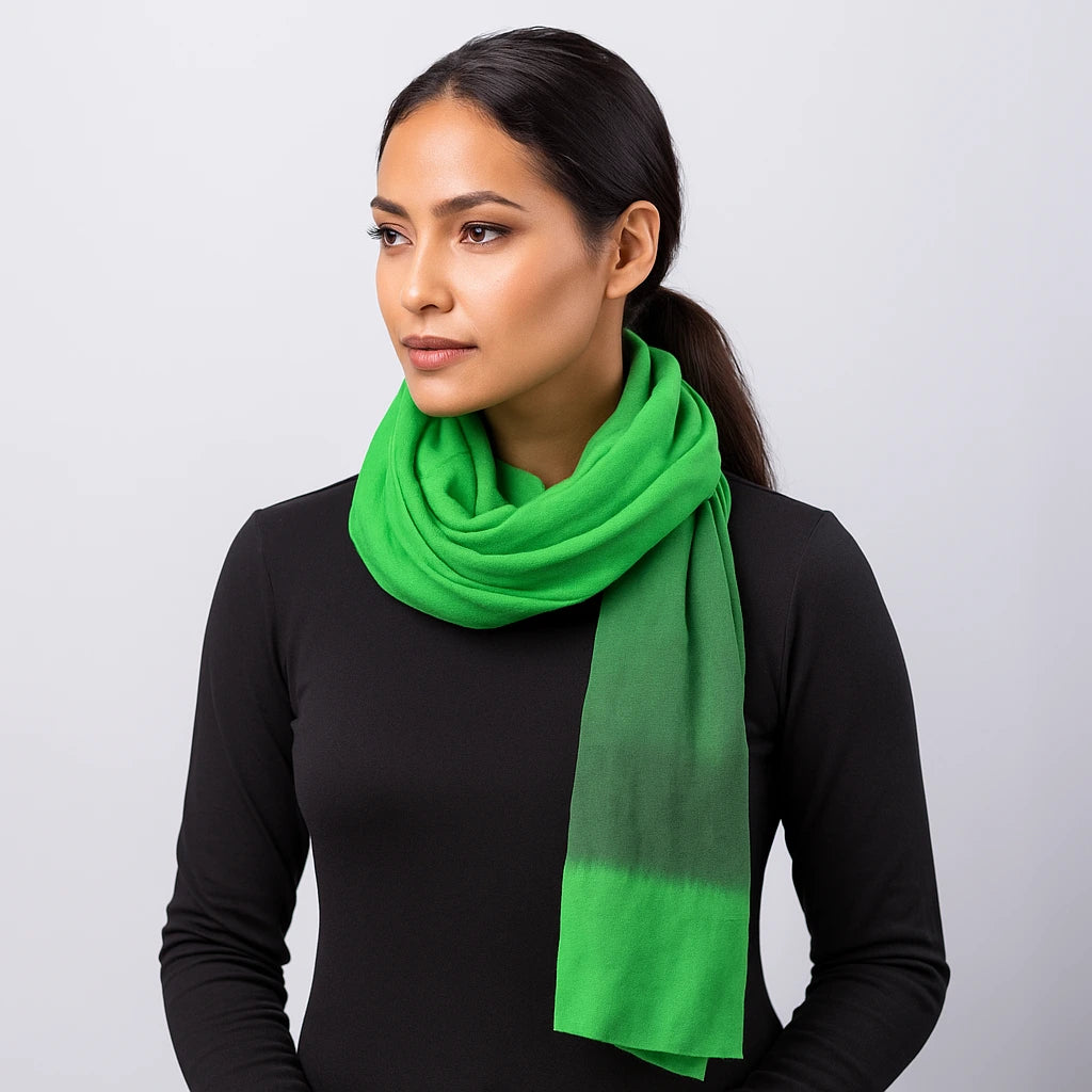 Woman wearing a bright green scarf against a plain background