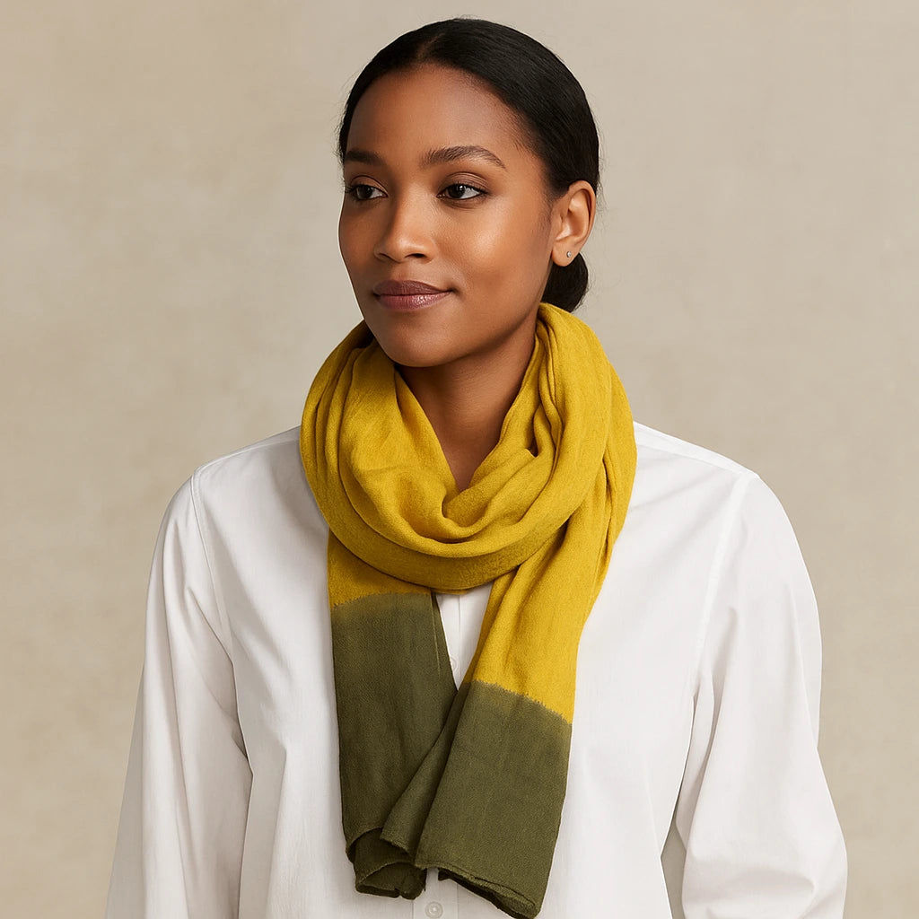 Woman wearing a mustard yellow and green scarf on a beige background