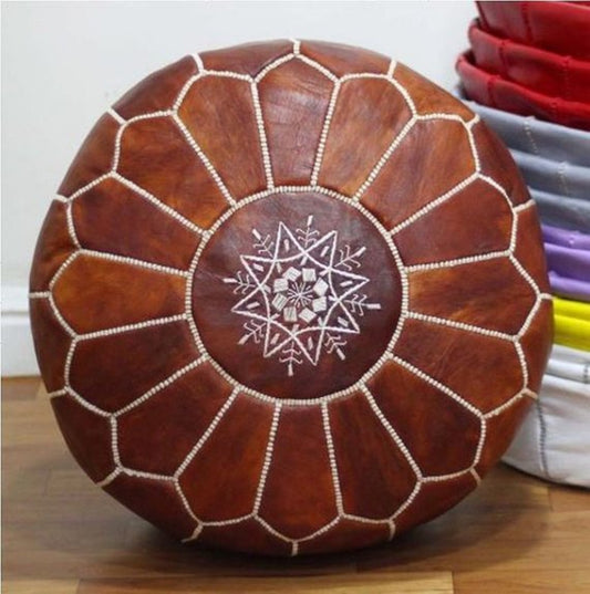 Handcrafted leather Moroccan poufs, ottomans and footstool in natural tones, featuring traditional stitching and soft, durable materials.