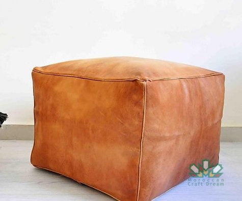 Handcrafted leather Moroccan poufs, ottomans and footstool in natural tones, featuring traditional stitching and soft, durable materials.