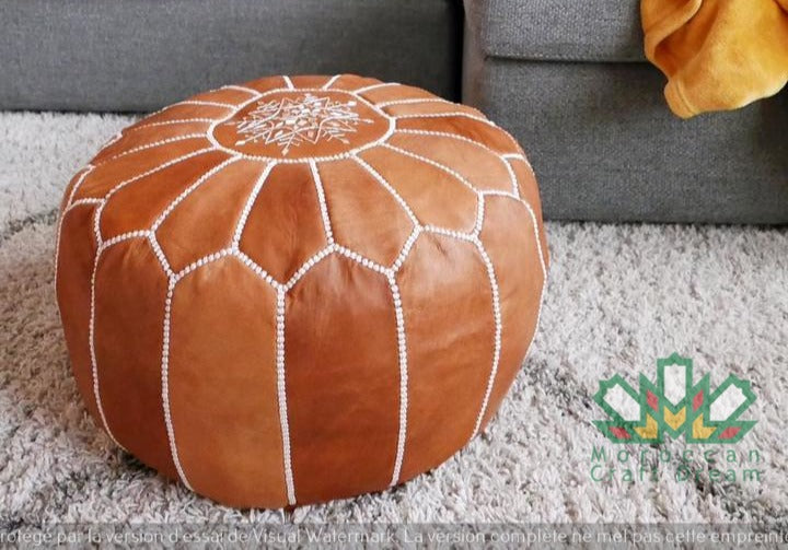 Handcrafted Moroccan leather poufs, ottomans and footstool in natural tones, featuring traditional stitching and soft, durable materials.