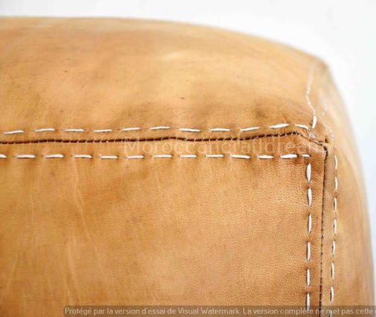 Handcrafted leather Moroccan poufs, ottomans and footstool in natural tones, featuring traditional stitching and soft, durable materials.