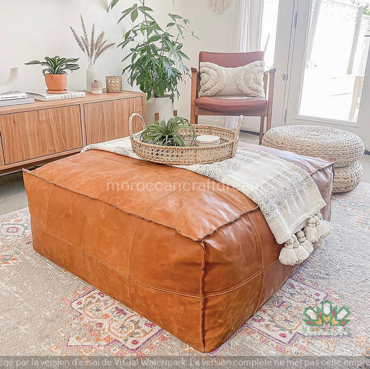 Handcrafted Moroccan leather pouf in caramel color, perfect for living room decor and extra seating.