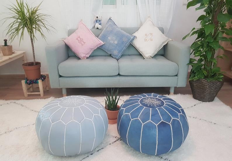 Handcrafted Moroccan leather poufs, ottomans and footstool in natural tones, featuring traditional stitching and soft, durable materials.