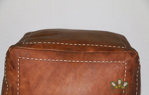 Handcrafted leather Moroccan poufs, ottomans and footstool in natural tones, featuring traditional stitching and soft, durable materials.