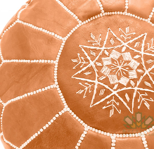 Handcrafted leather Moroccan poufs, ottomans and footstool in natural tones, featuring traditional stitching and soft, durable materials.