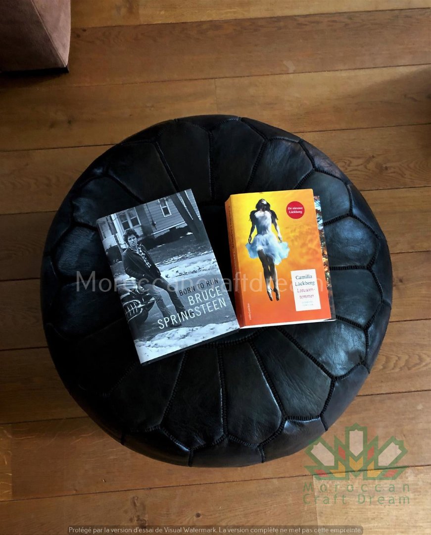 Black Handcrafted Moroccan leather pouf for living room decor, blending comfort with authentic Moroccan style.