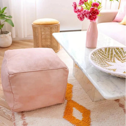 Handcrafted nude pink Moroccan leather poufs, ottomans and footstool in natural tones, featuring traditional stitching and soft, durable materials.