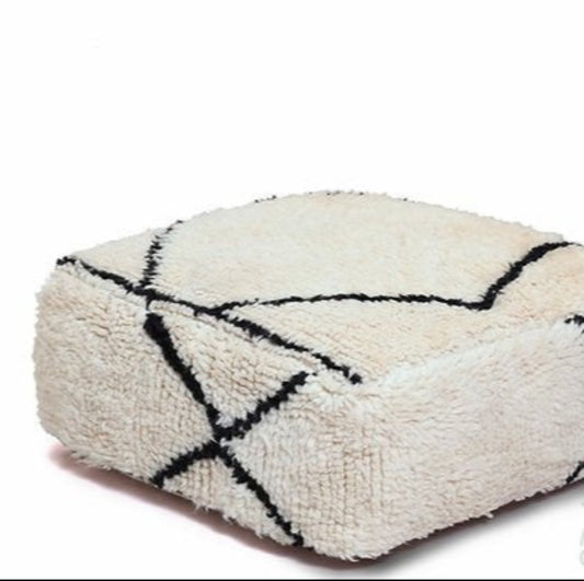 White black Kilim pouf made from rug and wool material, featuring vibrant patterns and traditional craftsmanship for stylish decor.