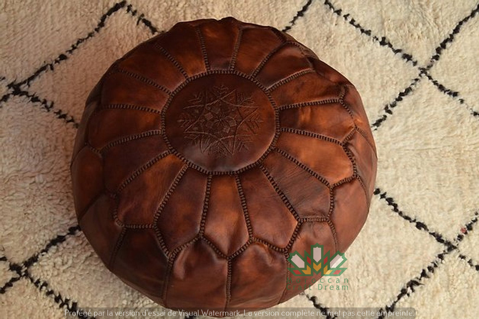 Luxurious brown tan leather Moroccan pouf ottoman by Moroccancraftdream, used as a footrest or extra seating option."