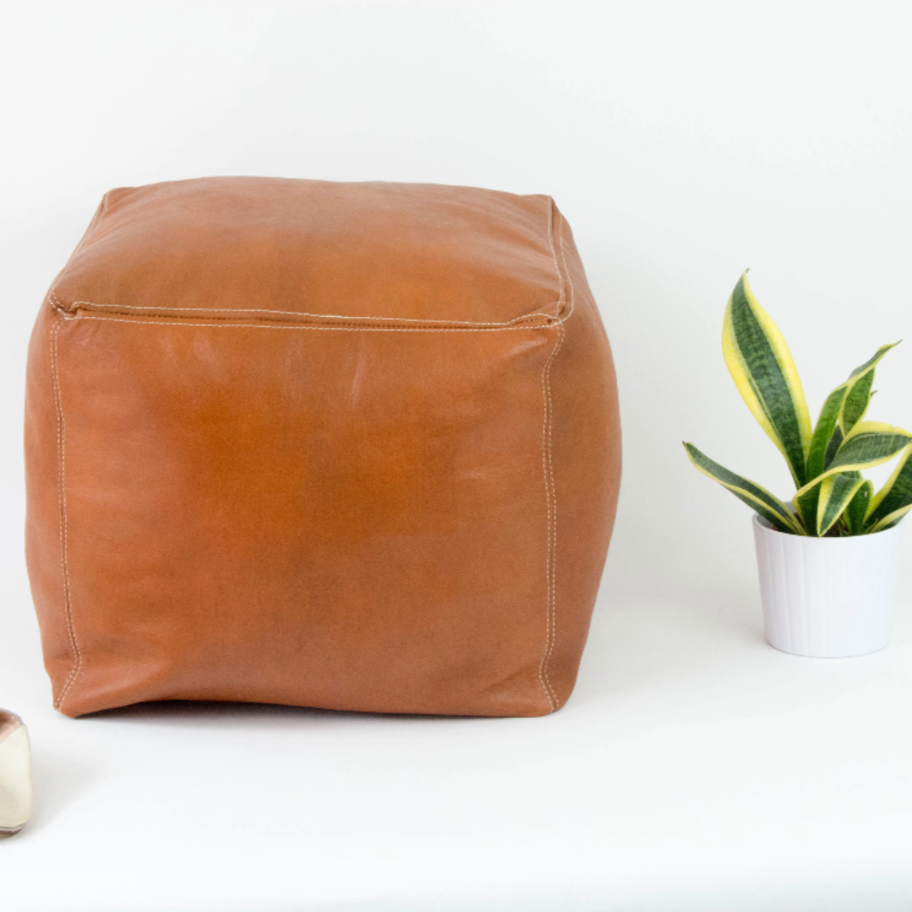 Handcrafted caramel color of leather Moroccan poufs, ottomans and footstool in natural tones, featuring traditional stitching and soft, durable materials.