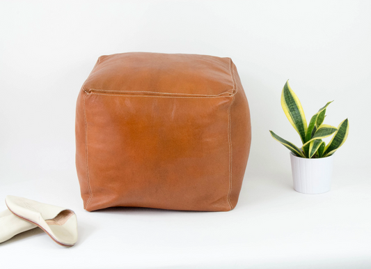 Handcrafted caramel color of leather Moroccan poufs, ottomans and footstool in natural tones, featuring traditional stitching and soft, durable materials.