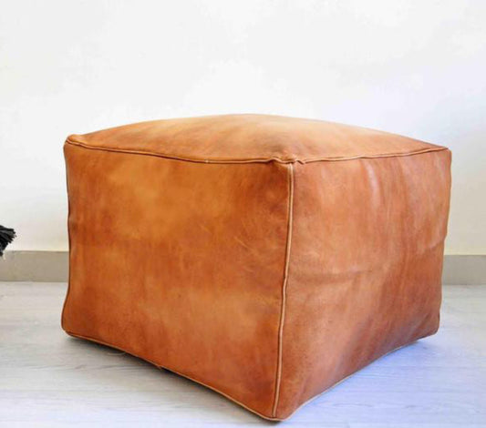 Handcrafted leather Moroccan poufs, ottomans and footstool in natural tones, featuring traditional stitching and soft, durable materials.