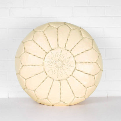 Cream Handmade Moroccan leather pouf ottoman used as a coffee table, in authentic goatskin leather, perfect for versatile home decor.