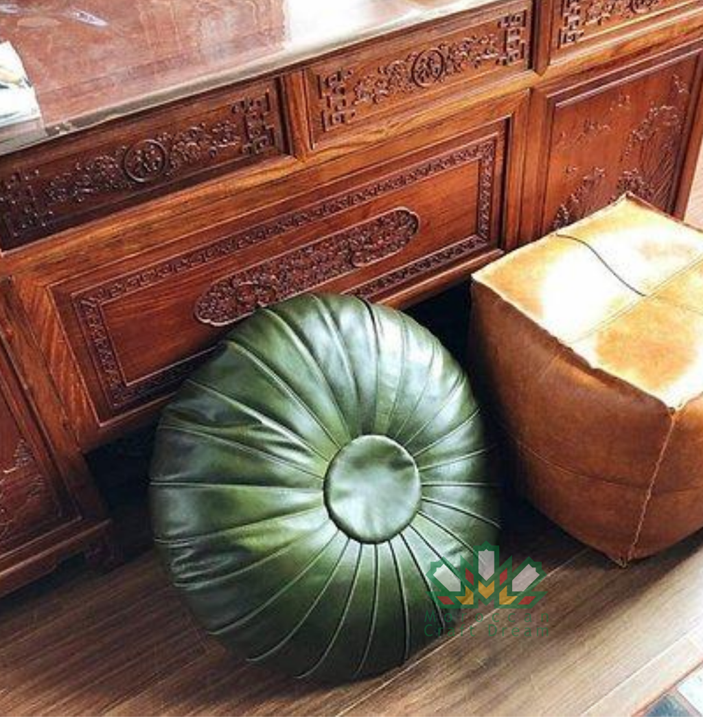 Green handmade round Moroccan pouf ottoman in genuine leather, perfect for use as a versatile coffee table or footrest. This Moroccan leather ottoman enhances living room decor with its elegant design and multifunctional use.