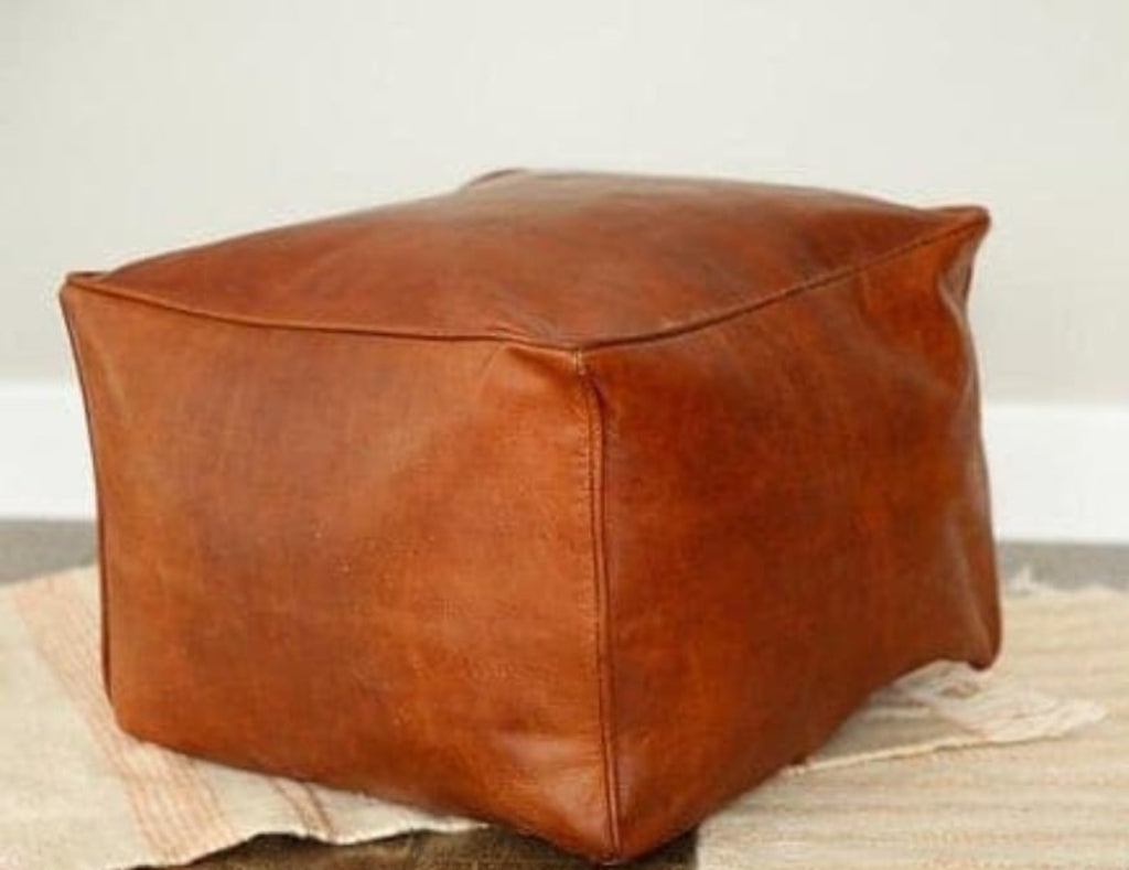 Handmade leather ottoman, Moroccan poufs, ottomans and footstool in natural tones, featuring traditional stitching and soft, durable materials.
