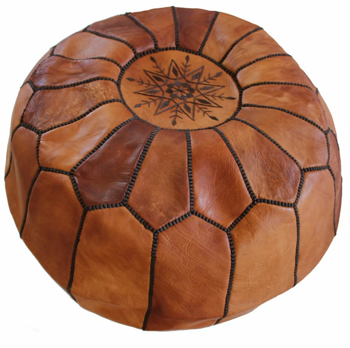 Round Moroccan leather poufs used as a coffee table, handcrafted with durable materials and traditional stitching in natural tones.