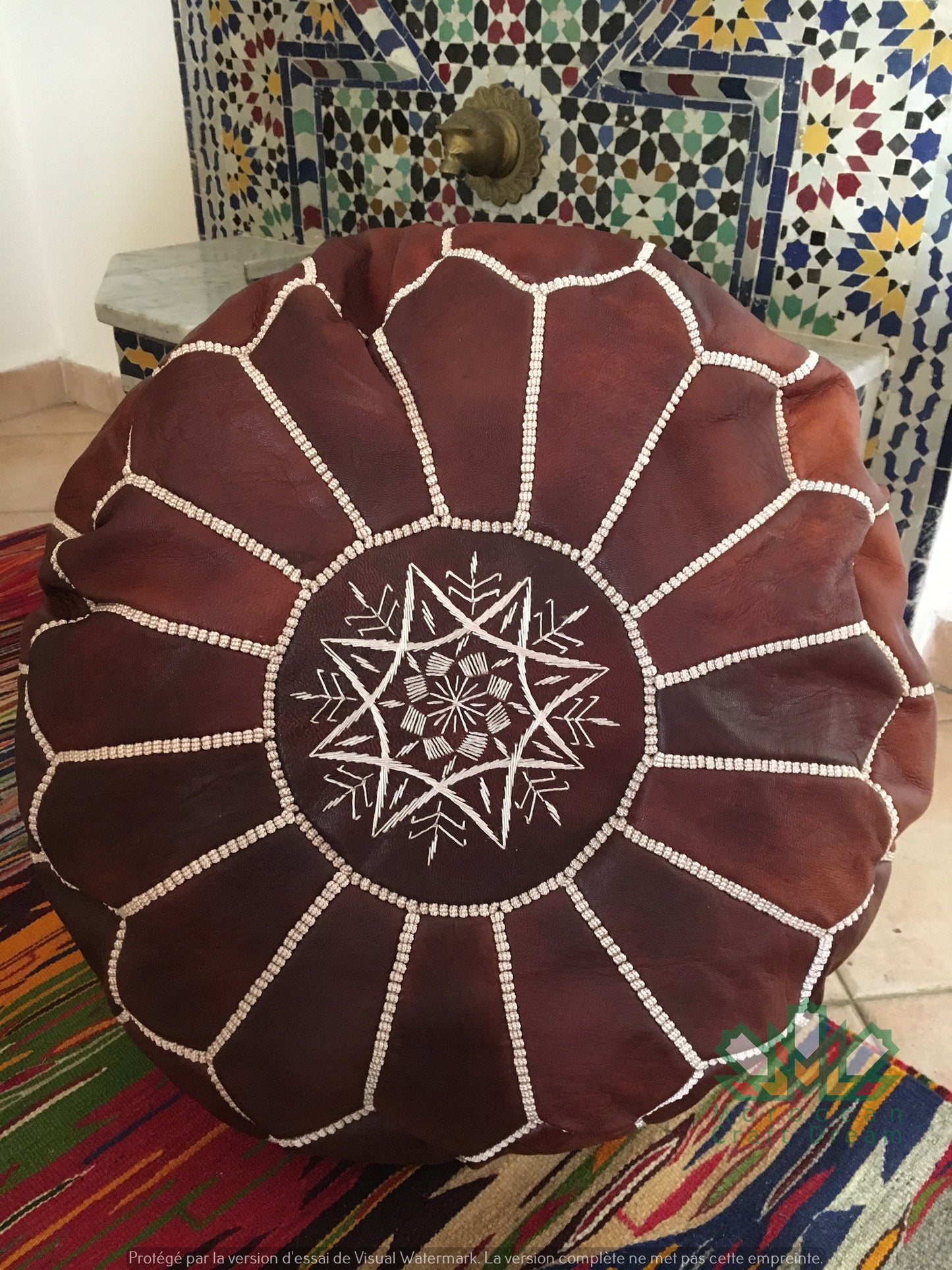 Round Moroccan leather poufs used as a coffee table, handcrafted with durable materials and traditional stitching in natural tones.