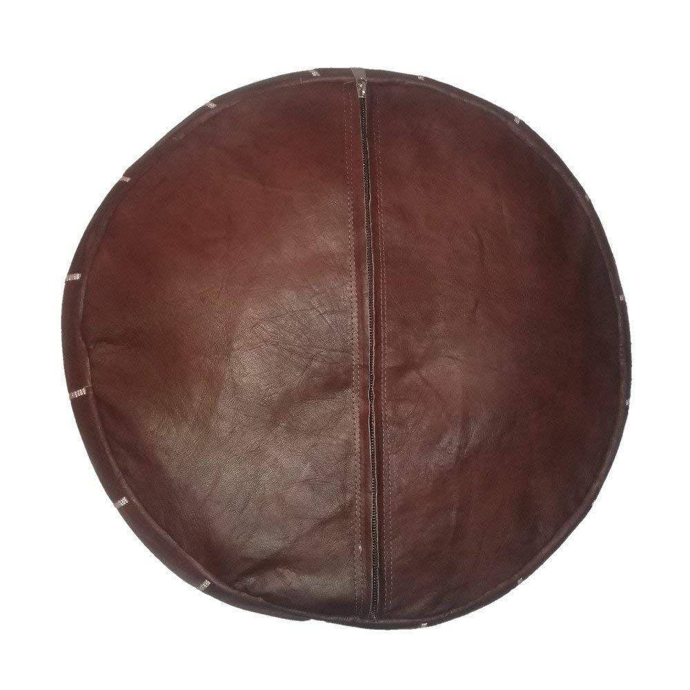 Round Moroccan leather poufs used as a coffee table, handcrafted with durable materials and traditional stitching in natural tones.